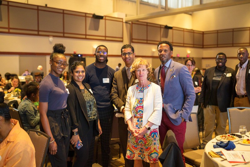 UD Provost Robin Morgan (fourth from left) stands with keynote speaker Wali Rushdan II and several of the 2019 Students of Distinction.