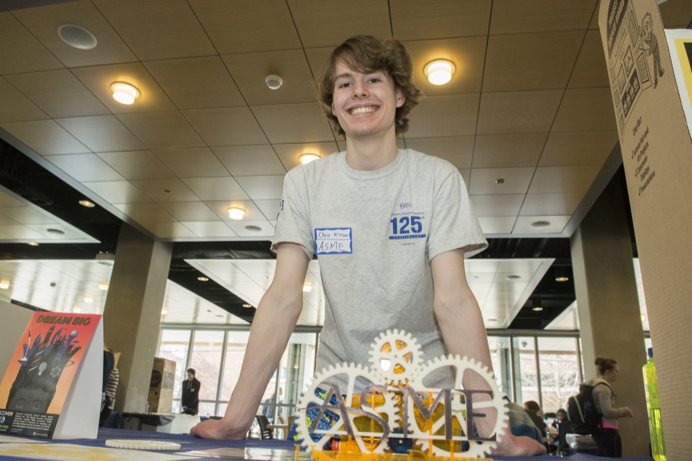 Shots of displays and speakers at the College of Engineering's Enginneers Week opening carnival in the lobby of Harker Lab