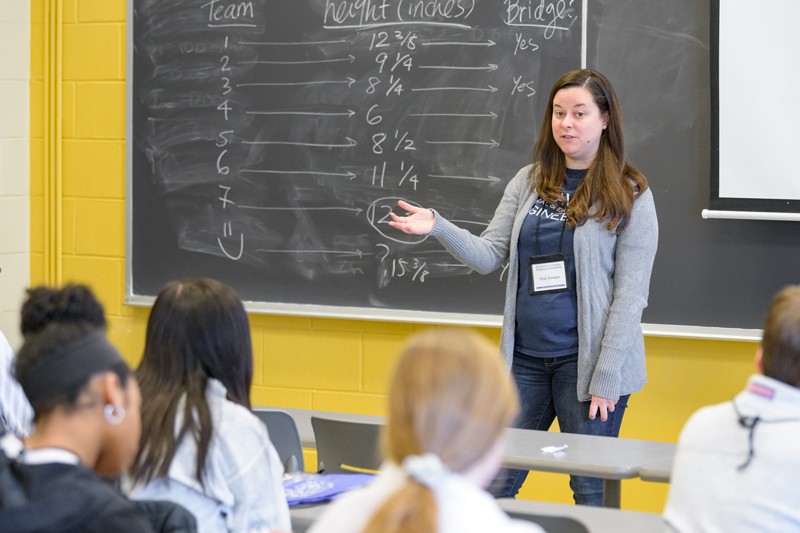 Cathy Fromen stands in front of a classroom