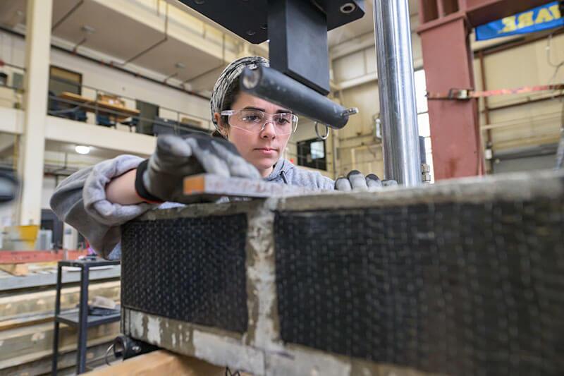 CEE-Structures_Lab-020723-126 Student runs test on concrete in the Structures Lab.