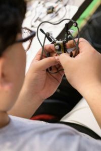 Yiming Wan holds a miniature drone