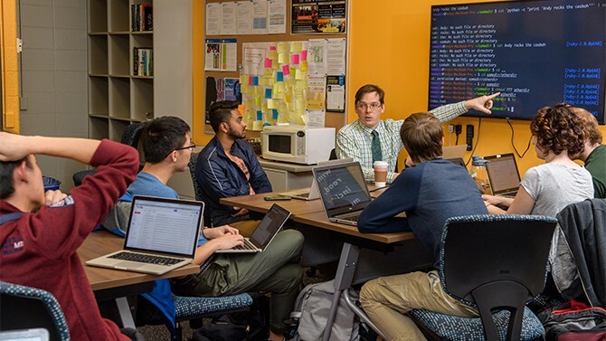 Prof. Andy Novocin meets with students