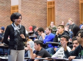 Arthi Jayaraman stands before a group of students.