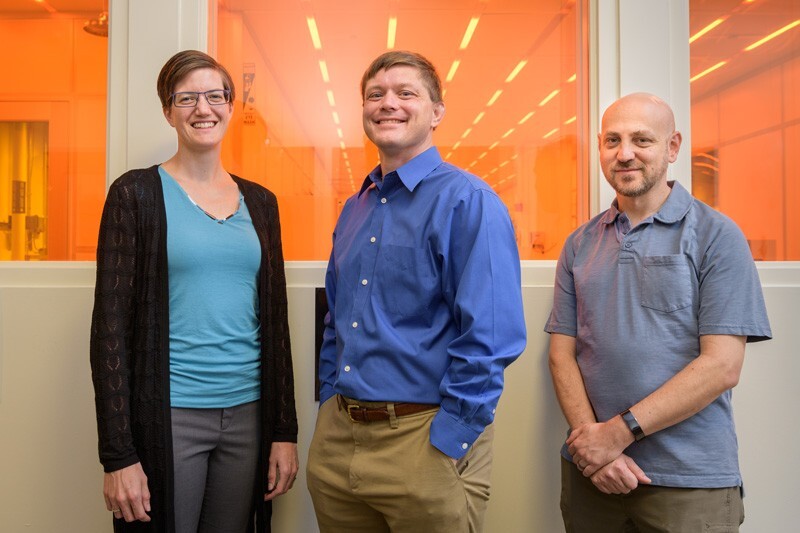 As part of a National Science Foundation initiative to advance the quantum technology revolution, University of Delaware researchers will explore a new approach to making quantum devices, 10,000 times smaller than the width of a human hair, in UD’s Nanofabrication Facility, shown behind them. Project leader Matthew Doty (center) is flanked by team members Stephanie Laws and Joshua Zide. All are professors in UD’s Department of Materials Science and Engineering.