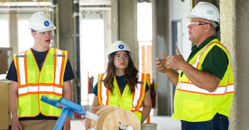 UD students Nick Sabatini and Alexa Johnson, and Craig Sams, a senior project project manager at Bancroft Construction, are pictured touring the STAR tower when it was under construction earlier in 2018.