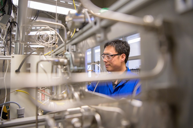 Bingjun Xu, an assistant professor of chemical engineering, is pictured with a tool his research group developed to determine the oxidation state of catalysts.