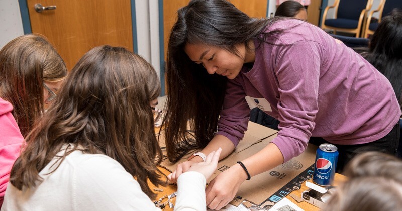 UD senior engineering student Abigail Dela Paz is pictured helping high school students build circuits during Engineering Discovery Day.