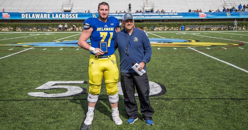 University of Delaware offensive lineman Collin Wallish (left) and football coach Danny Rocco are pictured after the spring game at Delaware Stadium.