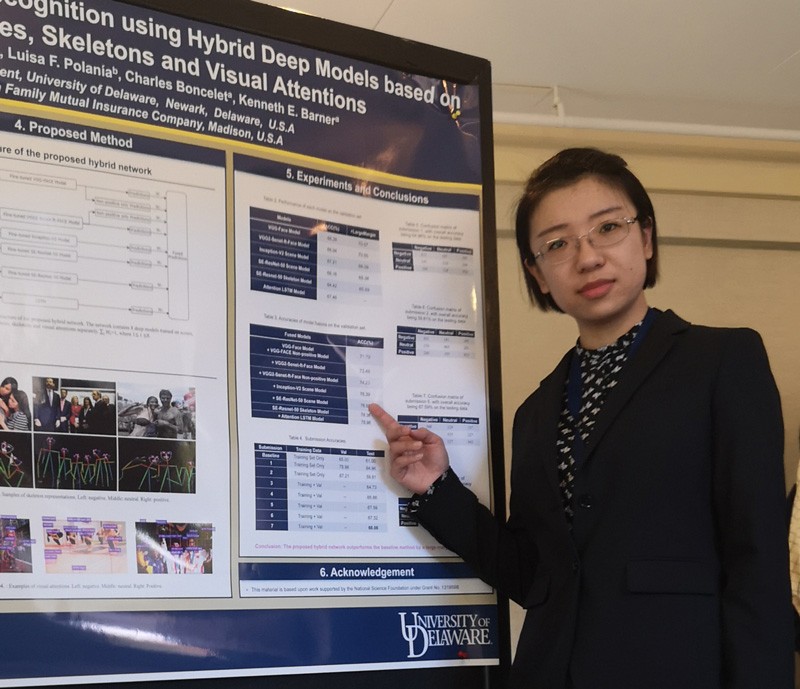 Cindy Guo is pictured with her research poster at EmotiW 2018.