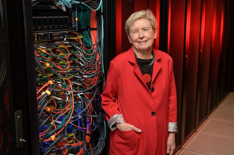 Jane Caviness, director of the University of Delaware's Academic Computing Services in the 1980s and who later oversaw the implementation of the NSF Network (NSFNET) backbone, photographed with an eponymously named community computing cluster in IT's Chapel Street computing center. The Caviness Community Cluster is UD's third High Performance Computing (HPC) cluster and came online in October of 2018 for UD research use.
