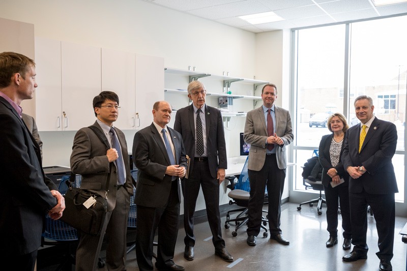 Several researchers, including Keith Schneider (left), director of the Center for Biomedical and Brain Imaging, talked about their work during NIH Director Francis Collins’ tour. Among those present were (left to right): National Institute for Innovation in Manufacturing Biopharmaceuticals (NIIMBL) Director Kelvin Lee, U.S. Sen. Chris Coons, Collins, UD Prof. Curtis Johnson, Eleni Assanis and UD President Dennis Assanis. 
