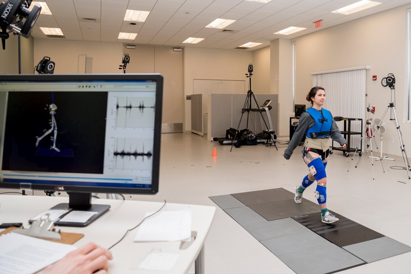 Megan Leibowitz, a doctoral student in physical therapy, demonstrates motion capture technology used to study how people walk.