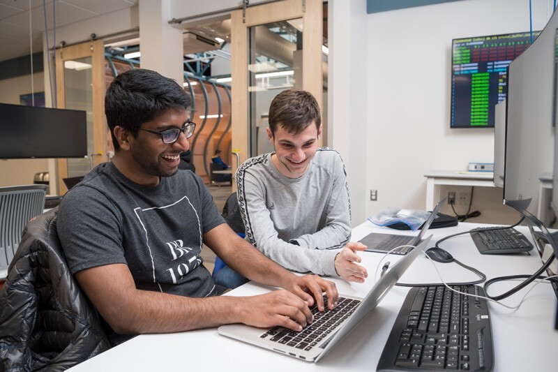 Students Vineeth Gutta (left) and Dan Goodman regularly meet in the iSuite at Evans Hall to work on cybersecurity projects. 