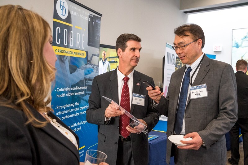 “UD Day in DC” attracted leaders from federal agencies that support UD research. Here, Steven Stanhope (center), associate vice president for research at UD and director of Delaware INBRE, talks with Ming Lei of the National Institutes of Health.
