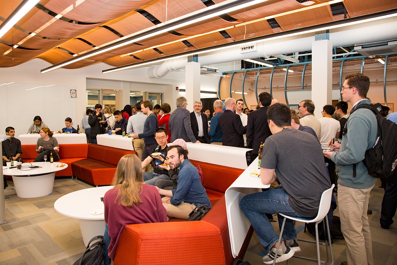 Students, faculty and alumni celebrate in the iSuite, a facility that includes a cyber range, makerspace, and collaboration hub. 