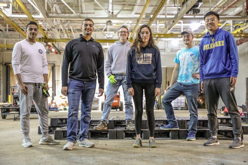 UD students utilized warehouse space at 1743 Holdings LLC, to prepare two pallet stages for the University’s Early Learning Center. From left to right are Omar Abdullah, Lucas Attia, Jeffrey Spencer, Phoebe Dowden, George Wieber and Logan Kim.