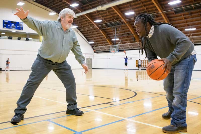 Sociologist Chad Starks and astrophysicist Bill Matthaeus play basketball