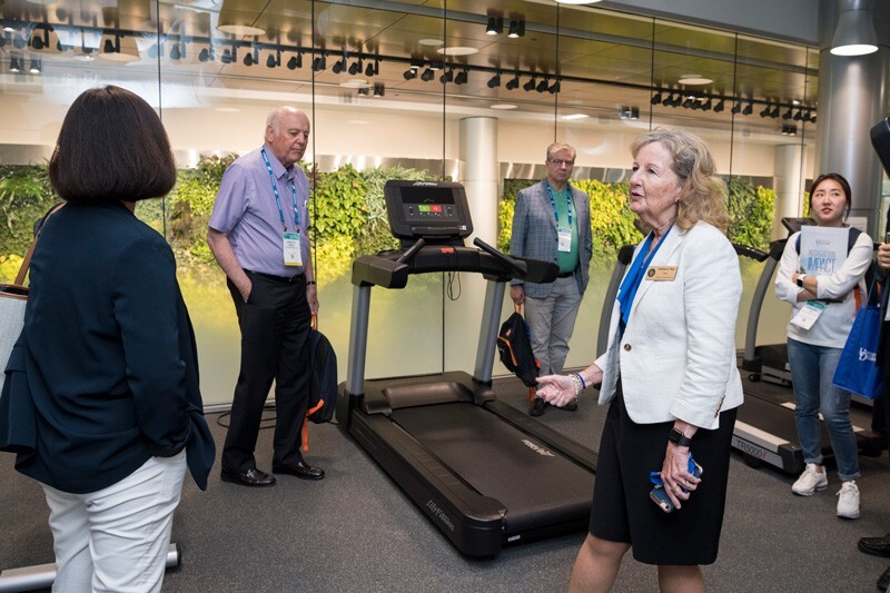Dean Kathy Matt shows BIO 2019 visitors a physical therapy lab