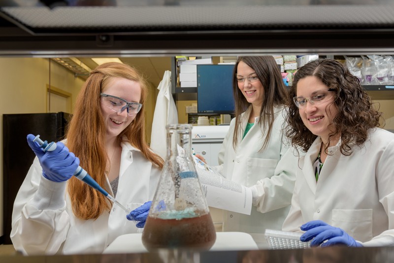 UD Engineering Prof. Emily Day (center) works in the laboratory with students Maggie Billingsley and Rachel Riley.