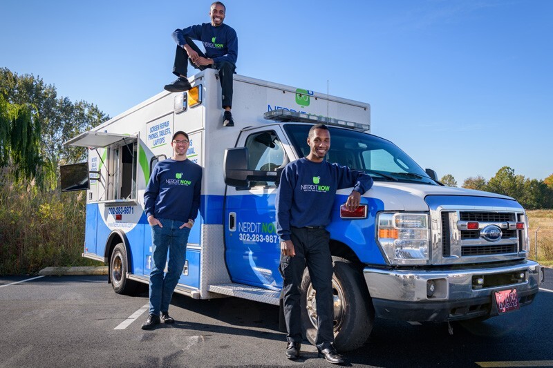 Left to right, Markevis Gideon, Jake Voorhees and Jonathan Hoxter, who run NerdiT Now, stand in front of their retrofitted ambulance, affectionately called “The Motherboard.”
