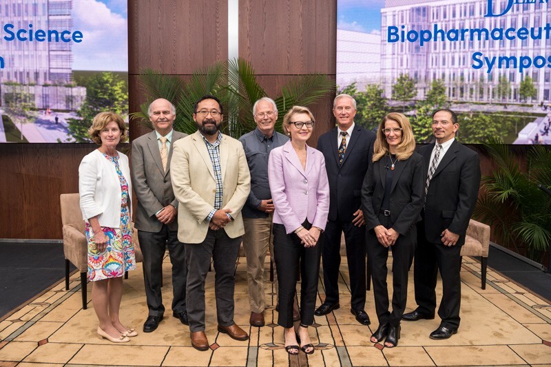 University of Delaware Provost Robin Morgan (far left) and Delaware Biotechnology Institute Director John Koh (far right) join the speakers at the recent biopharmaceutical symposium at UD’s Science, Technology and Advanced Research (STAR) Campus.