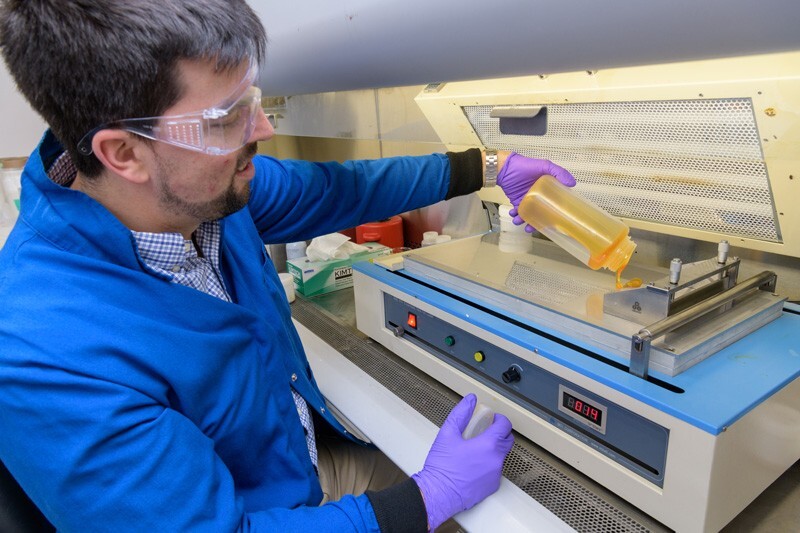Jared Nash, chemical engineer, pours W7energy’s novel polymer onto a membrane caster in order to produce the startup company’s unique PiperION membranes for fuel cell applications.