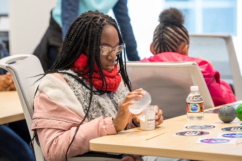 A girl makes oobleck, a slime that exhibits properties of both solids and liquids