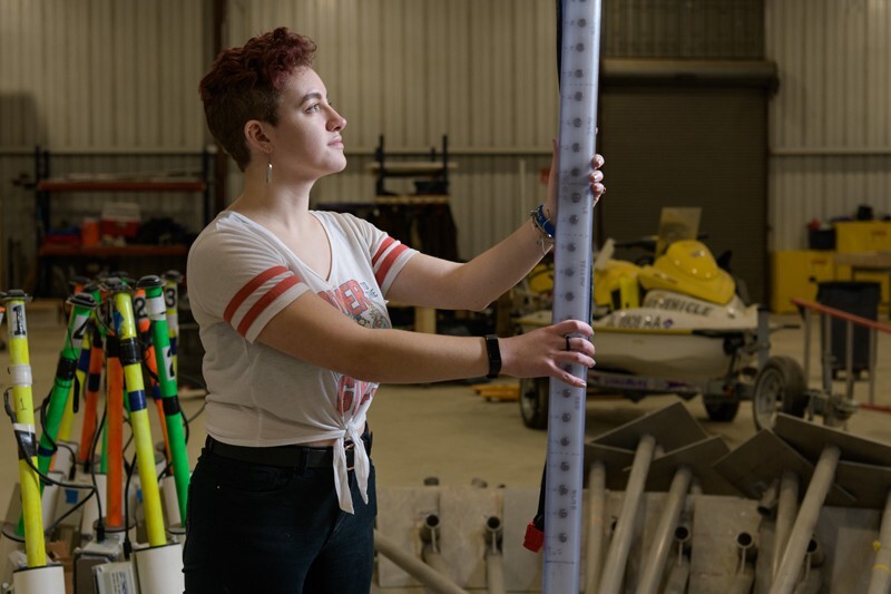 Sydney Cargill, pictured here in UD’s Coastal Engineering Lab, is using a solar array, equipped with 30 sensors that detect light, to study the movement of sand during heavy wave action on a beach. The results could be used by town and resource managers in strategizing best ways to mitigate erosion.