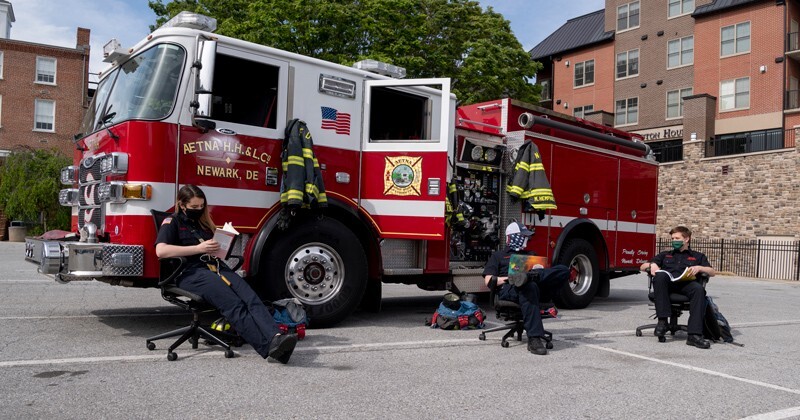 UD students Olivia Alexander (left), Mark Doyle (center) and Michael Hemphill participate in the live-in program at Aetna Hose, Hook and Ladder Company in Newark, meaning they volunteer as firefighters in exchange for free housing. When most of their peers left campus to ride out COVID-19 at home with loved ones, these first responders stayed behind to serve their community.