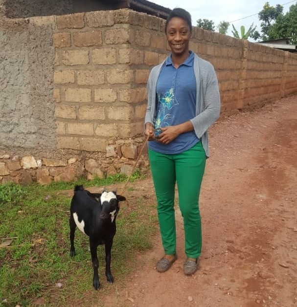 Leah Putman poses with a goat she gave to a neighbor in Rwanda. Putman works in the country as the Technical Director for Sustainable Health Enterprises.
