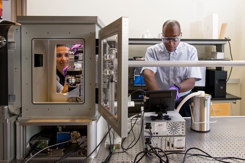 Prof. Thomas Epps (right) works in his lab with a graduate student.