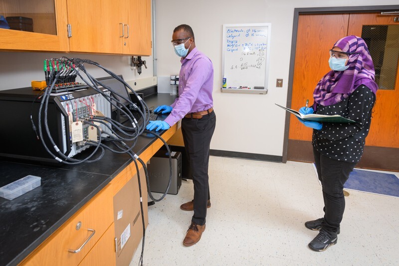 Prof. Koffi Pierre Yao mentors doctoral candidate Rownak Jahan Mou as they work to create a better (and more affordable) lithium ion battery for electric vehicles.