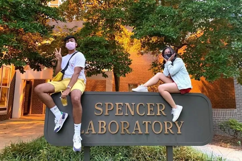 Recent graduate Showvik Haque (left) joked that Spencer Lab, home of the Mechanical Engineering Department at UD, is his “home.” He and fellow mechanical engineering major Allysa Tuano, a senior, have been best friends since sixth grade. They are pictured sitting atop the Spencer Lab sign.