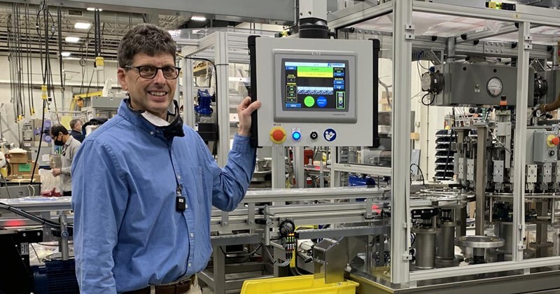 Alumnus Mike Seitel, Class of 1987, stands by an automation system at his company, Norwalt Design, Inc.