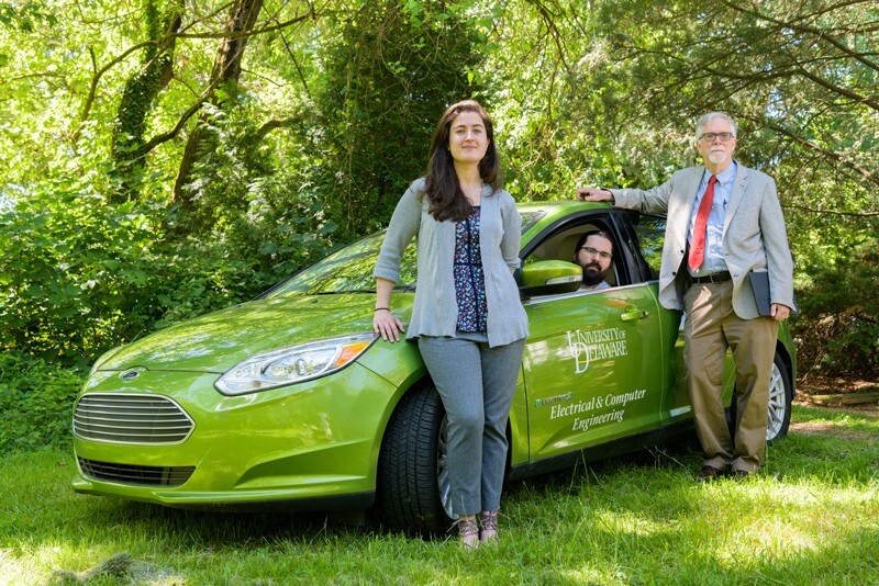 From left to right, the University of Delaware’s Sara Parkison, Rodney McGee and Willett Kempton are shown with a UD test vehicle used in the research for V2G technology