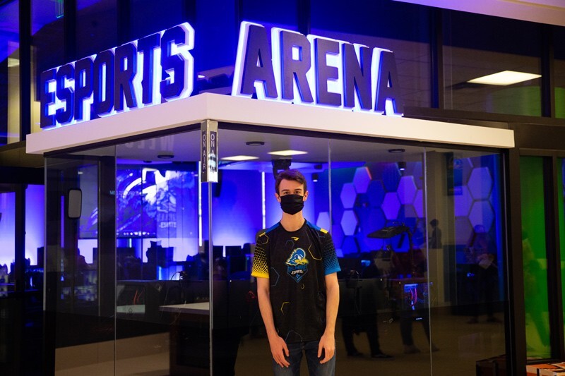 Tyler Grau, a senior chemical engineering major from Pittsburgh, Pennsylvania, stands in front of the Esports Arena.