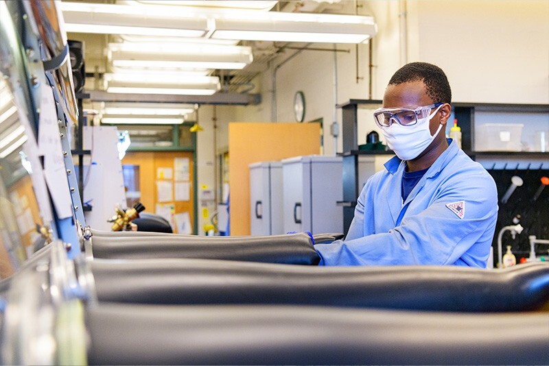 Olamide Idowu prepares to work in a sealed chemical hood.