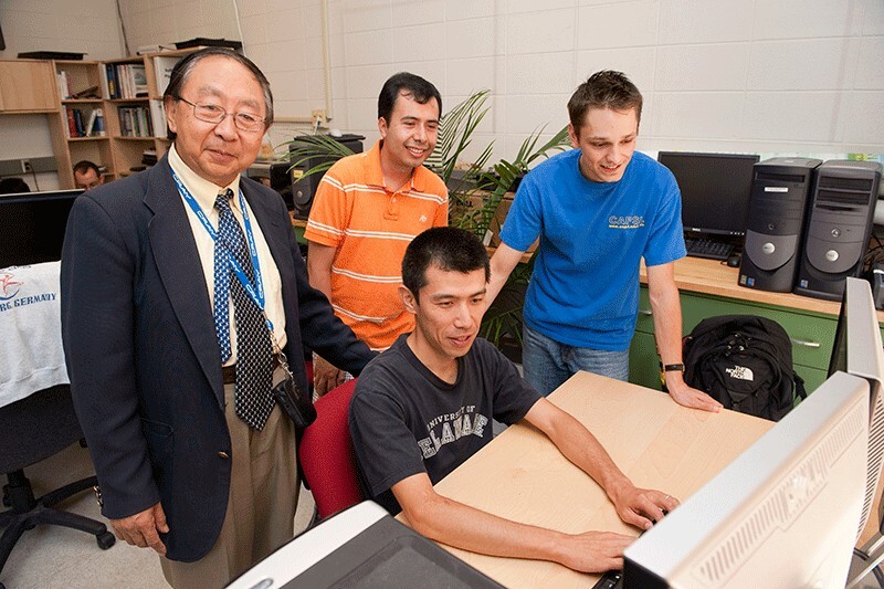 Dr. Gao with students in an Evans Hall lab from 2010.