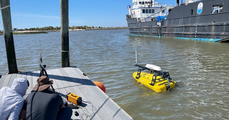Students enrolled in the Master of Science in Robotics program got hands-on experience during a semester-long internship with Seafloor Systems Inc., where they worked to install a mission planning system on one of the company’s EchoBoats, an unmanned surface vessel used for hydrographic surveying. Pictured are two of the students working with the EchoBoat out on the water at UD’s Hugh R. Sharp Campus in Lewes.