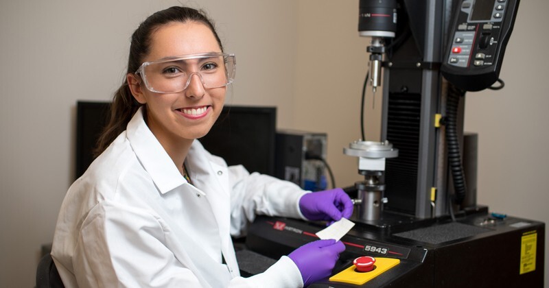 UD senior engineering major Erin Hogan is among the undergraduate and graduate students who have gained experience and advice from UD Prof. Norm Wagner. In this 2018 photograph, Hogan tests fabric for use on the International Space Station.