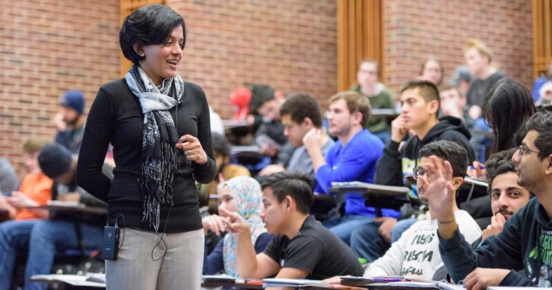 In this photo taken before the coronavirus pandemic necessitated the wearing of masks and distancing in classrooms, Prof. Arthi Jayaraman speaks with students in her chemical engineering class.