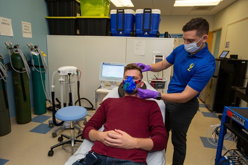 Doctoral student Ted DeConne (right) utilizes blood testing on Houston Ward to analyze the effects of added sugar intake on brain blood flow and hippocampal function.