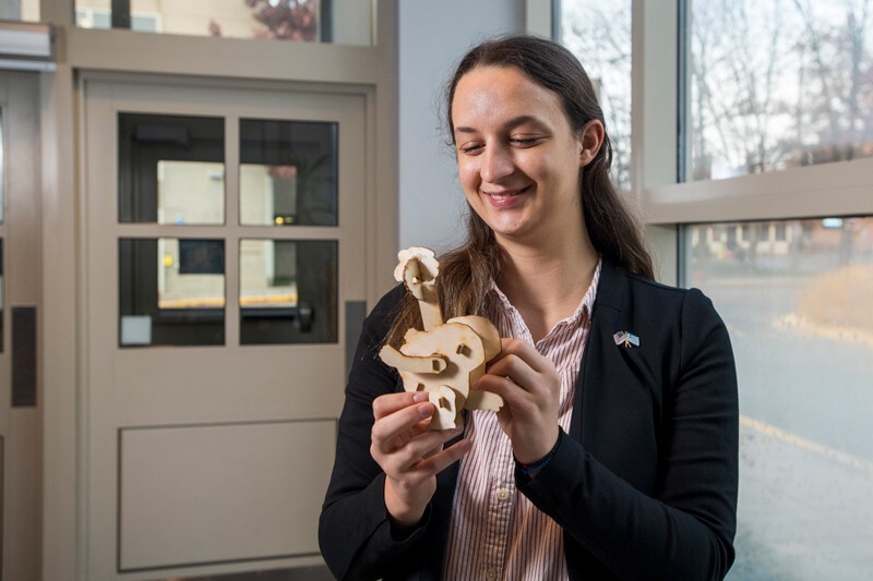 First-year Engineering student Geogia Angeletakis holds the birchwood model of the University’s YouDee mascot, complete with flapping wings