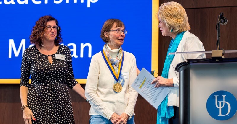 Pam Cook (center) is presented with the University's Medal of Distinction by Debra Hess Norris (right), chair of the Trustee and Faculty Committee on Honorary Degrees and Awards, and Beth Brand (left), vice president and University secretary.
