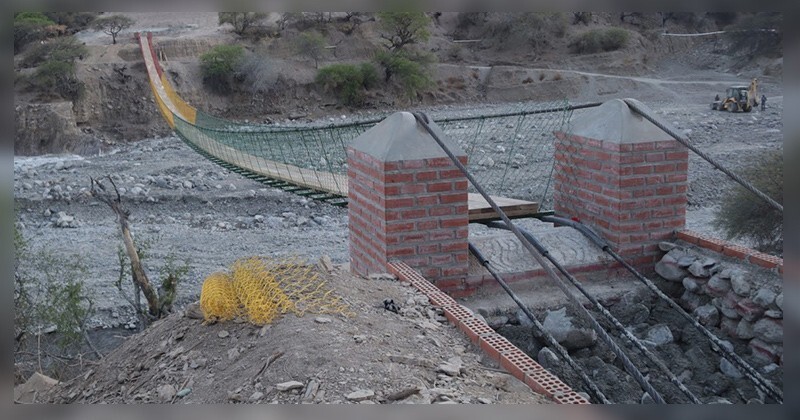 A 113-meter-long pedestrian suspension bridge in Bolivia. With Brick supports, heavy wire and wooden platform.