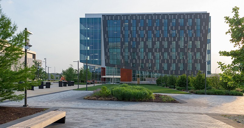 FinTech Innovation Hub with brick patio and lawn in the foreground.