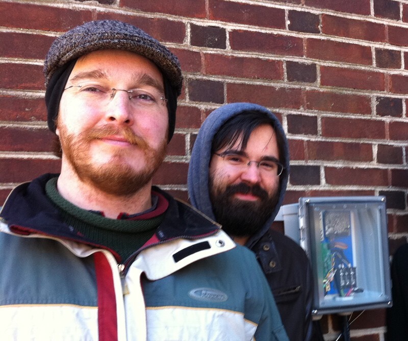 Study co-author Nathaniel (Nat) Pearre, left, who received his doctorate from the University of Delaware, is shown with Rodney McGee (right) and a prototype charging station. 