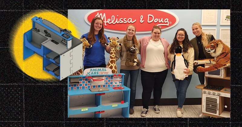 From left to right, Bethany Newton, Sarah Bartlett, Dani Moore and Zoe Smith worked with Melissa & Doug’s Rachel Belter (middle). The students are posed with stuffed animals. An inset image is a computer-aided image of their toy kitchen design.
