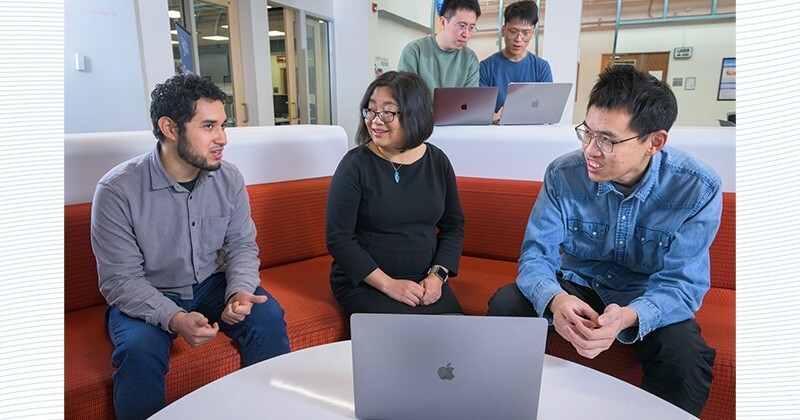 Fang, pictured with Damian Martinez (foreground left), Yue Zhang (right), Fumian Chen (back left) and Dayu Yang in the ECE iSuite, has an interdisciplinary research portfolio, from text mining in chemical engineering to improving disaster responses.