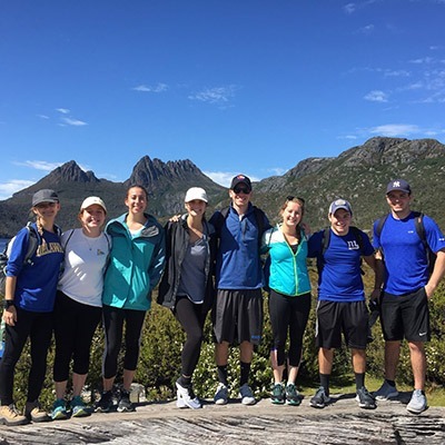 Group of students on study abroad in a line with a mountain view in the background